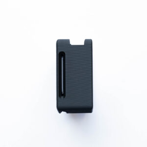 Close-up of a black plastic device with two rounded protrusions at the top, against a white background.