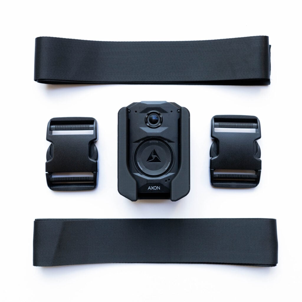 Black modular device and two mounts arranged on a white background, central unit labeled AXON with surrounding components.